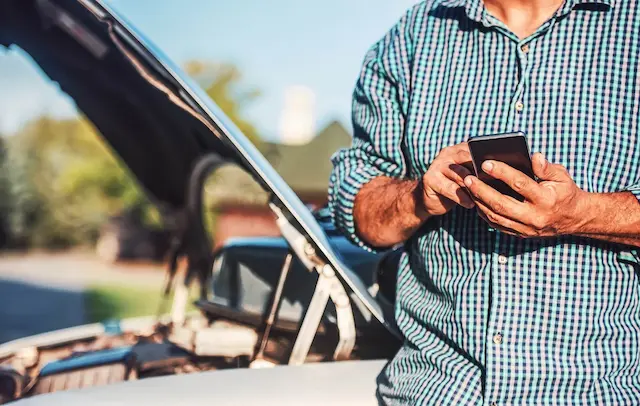 Man calling mobile tire repair service after his car stopped working